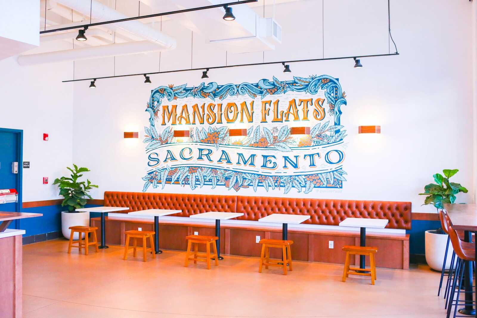 A large wall mural inside Goodside Coffee reads Mansion Flats Sacramento