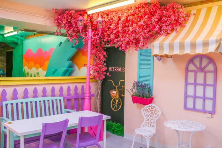 Pastel café-style seating area inside Cerealism cereal bar in Sacramento.